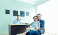 Young friendly caucasian pediatrician doctor is examining child patient girl with her mother ,consultation with a stethoscope and Royalty Free Stock Photo