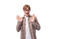 young friendly caucasian red-haired guy in a shirt over a t-shirt