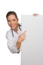 Young friendly doctor with an empty white poster