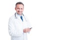 Young and friendly doctor or medic texting on smartphone Royalty Free Stock Photo