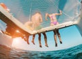 Young friends chilling in catamaran boat - Group of people making tour ocean trip - Travel, summer, friendship, tropical concept Royalty Free Stock Photo