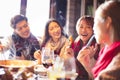 Young friends eating hot pot in restaurant at winter Royalty Free Stock Photo