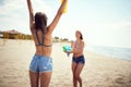 Friends female have fun at the beach in summer holiday vacation playing with water guns Royalty Free Stock Photo
