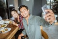 friends having fun eating lunch together at home with traditional food Royalty Free Stock Photo