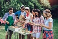 Friends having fun grilling meat enjoying barbecue party Royalty Free Stock Photo