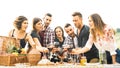 Young friends having fun outdoors drinking red wine at barbecue garden party Royalty Free Stock Photo