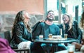 Young friends having genuine fun drinking on happy hour at street bar - Millenial people laughing and spending time together -