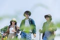 Young friends hiking travel in nature. Group backpacker walking trip journey adventure in countryside. Together in nature summer Royalty Free Stock Photo