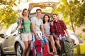 Young friends make selfie photo with smartphone in the trunk on camping trip Royalty Free Stock Photo