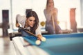 Young friends playing billiard