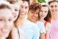 Young friends in a row smiling Royalty Free Stock Photo