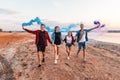 Young friends running with hand flare or fusee Royalty Free Stock Photo