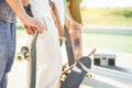 Young friends with skateboards at city skatepark - Millennials people holding boards having fun skating and listening music - Royalty Free Stock Photo