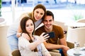 Young friends taking selfie while sitting at cafe Royalty Free Stock Photo