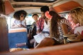 Young friends talking in camper van