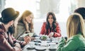 Young friends toasting coffee and doing breakfast in bar bakery shop - Happy hipster people drinking cappuccino and eating muffins Royalty Free Stock Photo