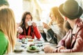 Young friends toasting coffee and doing breakfast in bar bakery shop - Happy hipster people drinking cappuccino and eating muffins Royalty Free Stock Photo