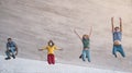 Young friends wearing face mask jumping outdoor - Happy people having fun in city after corona virus quarantine Royalty Free Stock Photo