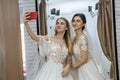 Young friends in wedding salon making selfie