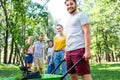 young friends with wheelbarrow and new trees volunteering