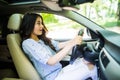 Young frightened driver woman squealing brakes avoiding an accident. Shocked girl tooting horn Royalty Free Stock Photo