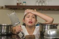 Young frustrated Asian woman in domestic chores stress - lifestyle home portrait of beautiful overwhelmed and stressed Korean girl Royalty Free Stock Photo