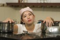 Young frustrated Asian woman in domestic chores stress - lifestyle home portrait of beautiful overwhelmed and stressed Korean girl Royalty Free Stock Photo