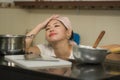 Young frustrated Asian woman in domestic chores stress - lifestyle home portrait of beautiful overwhelmed and stressed Korean girl Royalty Free Stock Photo