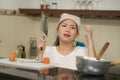 Young frustrated Asian woman in domestic chores stress - lifestyle home portrait of beautiful overwhelmed and stressed Korean girl Royalty Free Stock Photo