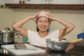 Young frustrated Asian woman in domestic chores stress - lifestyle home portrait of beautiful overwhelmed and stressed Korean girl Royalty Free Stock Photo