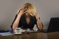 Young frustrated and stressed business woman crying at office desk working with laptop computer overwhelmed by paperwork workload Royalty Free Stock Photo