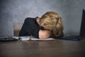 Young frustrated and stressed business woman crying sad at office desk working with laptop computer overwhelmed by paperwork workl Royalty Free Stock Photo