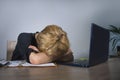 Young frustrated and stressed business woman crying sad at office desk working with laptop computer overwhelmed by paperwork workl Royalty Free Stock Photo