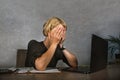 Young frustrated and stressed business woman crying sad at office desk working with laptop computer overwhelmed by paperwork workl Royalty Free Stock Photo