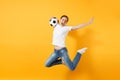 Young fun expressive European woman football fan jumping in air, cheer up support team, holding soccer ball isolated on Royalty Free Stock Photo