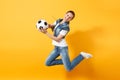 Young fun expressive European woman football fan jumping in air, cheer up support team, holding soccer ball isolated on Royalty Free Stock Photo