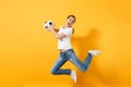 Young fun expressive European woman football fan jumping in air, cheer up support team, holding soccer ball isolated on Royalty Free Stock Photo