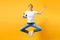 Young fun expressive European woman football fan jumping in air, cheer up support team, holding soccer ball isolated on Royalty Free Stock Photo