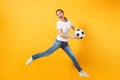 Young fun expressive European woman football fan jumping in air, cheer up support team, holding soccer ball isolated on Royalty Free Stock Photo