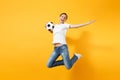 Young fun expressive European woman football fan jumping in air, cheer up support team, holding soccer ball isolated on Royalty Free Stock Photo