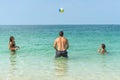 Young fun people are playing volleyball on the beach at the coast of Dubai. Positive human emotions, feelings, joy. Funny cute chi Royalty Free Stock Photo