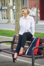 business woman sitting on a bench after work