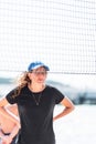 Young funny caucasian woman behind the net playing beach volleyball Royalty Free Stock Photo