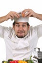 Young funny chef cracking an egg Royalty Free Stock Photo