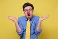 Young funny clown man with red nose and yellow tie showing ignorance Royalty Free Stock Photo