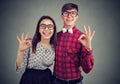 Young funny couple showig ok sign expressing excitement