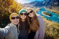 Young funny europian girls in sunglasses against mountain landscape make selfie, family travel and adventure, vacation concept