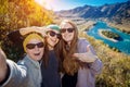 Young funny europian girls in sunglasses against mountain landscape make selfie, family travel and adventure, vacation concept Royalty Free Stock Photo