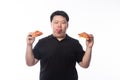 Young Funny Fat Asian man eating hawaiian and cheese pizza isolated on white background Royalty Free Stock Photo