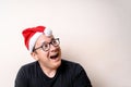 Young funny guy with christmas hat on white background. Sad santa. Christmas Royalty Free Stock Photo
